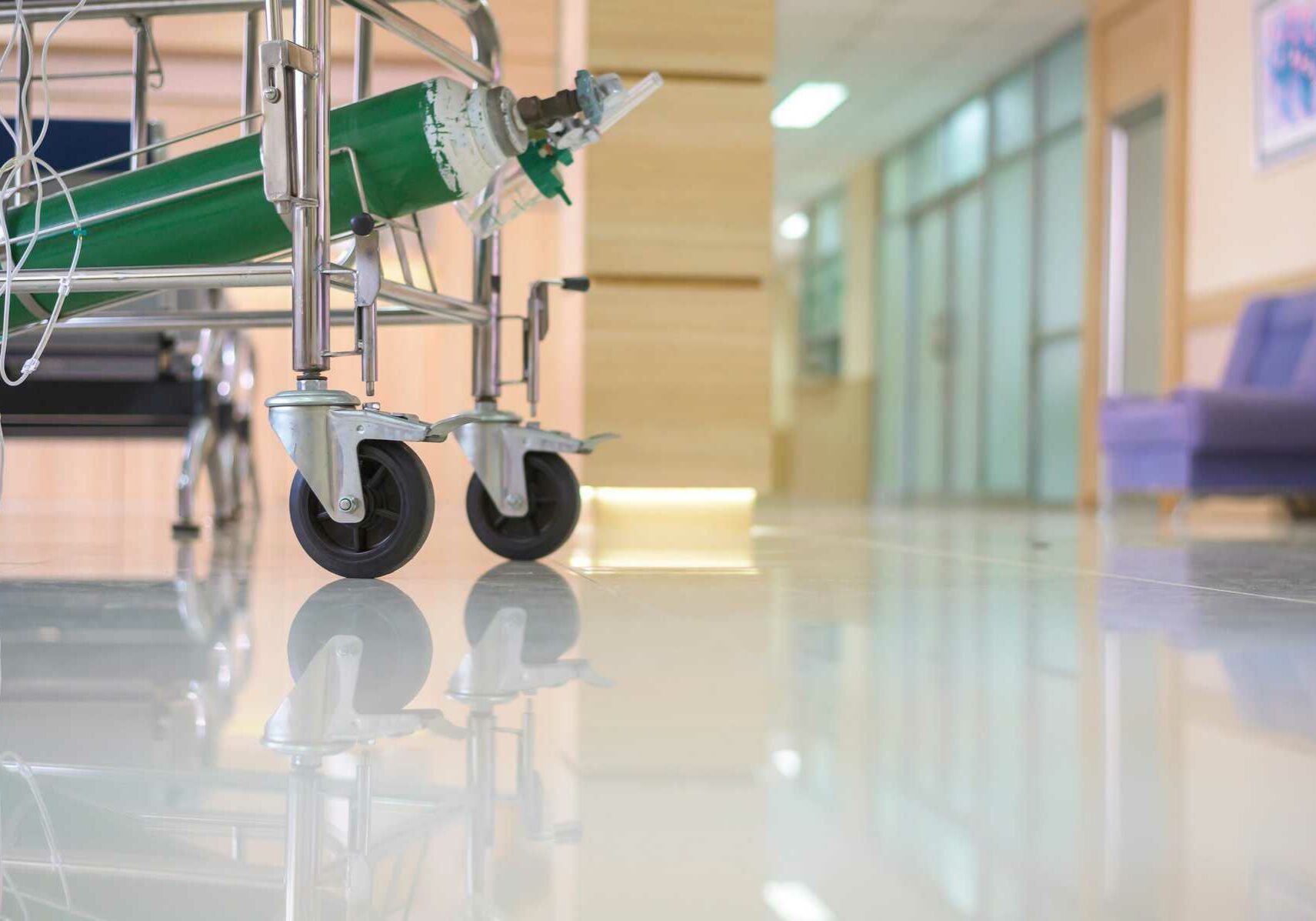 At the hospital corridor, an emergency stretcher with no patient. Stretchers are mostly utilized in hospital settings to transport people who need medical attention.
